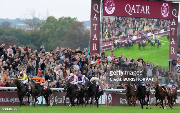 Irish jockey Mickael Kinane competes on "Sea the Stars" along with other jockeys during the 88th edition of the Arc de Triomphe prize, at the...