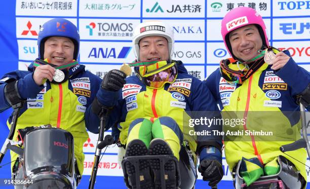 Silver medalist Kenji Natsume, gold medalist Akira Kano and bronze medalist Takeshi Suzuki pose on the podium at the medal ceremony for the Men's...
