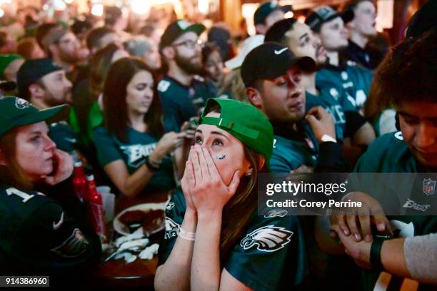 Megan Donovan of Philadelphia, Pennsylvania reacts to a Patriots score while watching Super Bowl LII on TV at The Irish Pub on February 4, 2018 in...