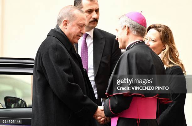 Turkish President Recep Tayyip Erdogan is welcomed by bishop Georg Gaenswein upon his arrival to meet with the Pope at the Vatican on February 5,...