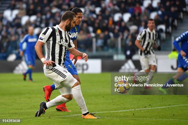 Gonzalo Higuain of Juventus competes for the ball with Mauricio Lemos of Sassuolo during the serie A match between Juventus and US Sassuolo on...