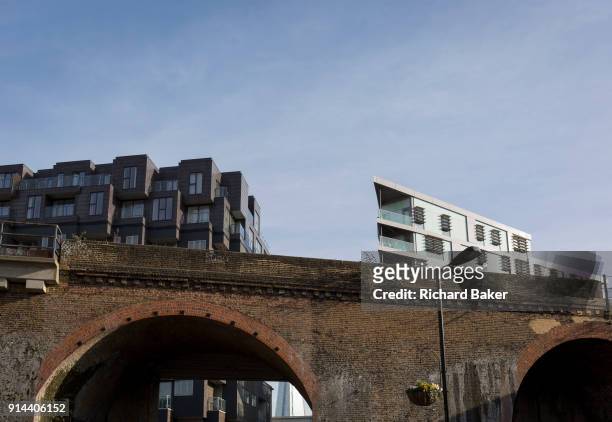 Old Victorian railway bridge and new housing in the borough of Southwark, on 30th January 2018, in London, England.