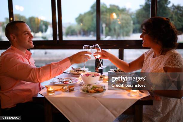 young couple enjoying romantic dinner - candle light dinner stock pictures, royalty-free photos & images