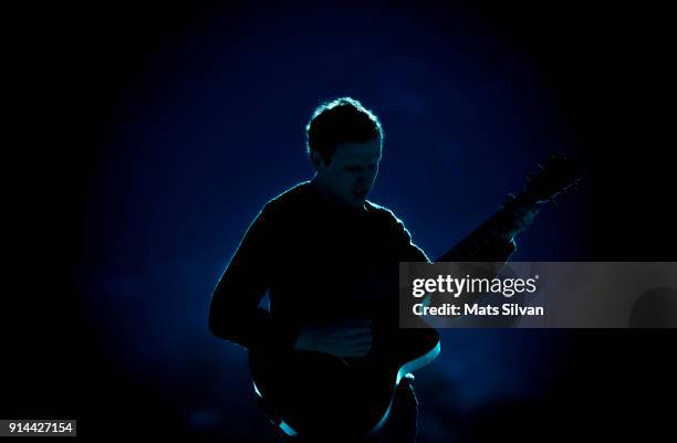 musician man playing on his guitar with backlit - dark background light stock-fotos und bilder