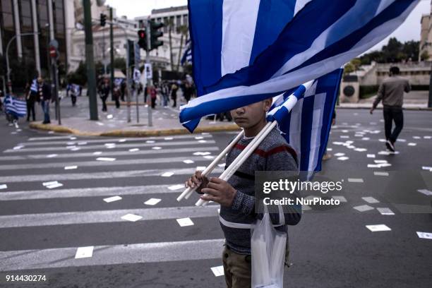 Demonstrators wave Greek national flags during a demonstration February 4, 2018 in Athens, Greece. Protesters gathered in the Greek capital for a...