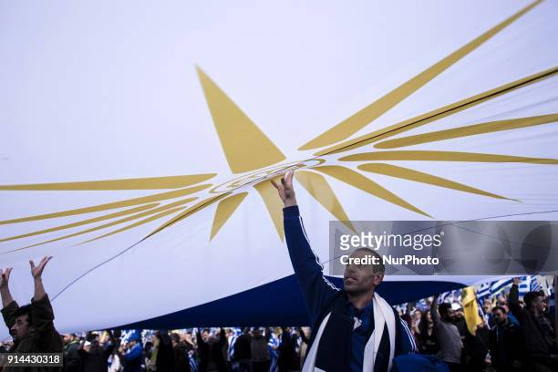 Demonstrators wave Greek national flags during a demonstration February 4, 2018 in Athens, Greece. Protesters gathered in the Greek capital for a...