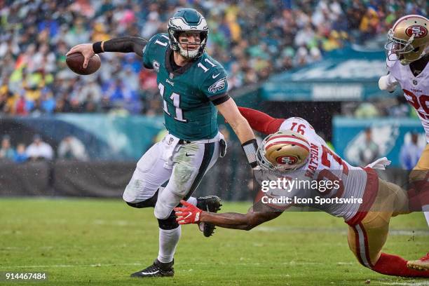 Philadelphia Eagles quarterback Carson Wentz battles with San Francisco 49ers linebacker Dekoda Watson during the NFL football game between the San...