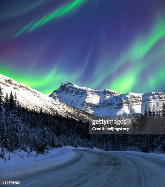 aurora and road - aurora borealis stock pictures, royalty-free photos & images