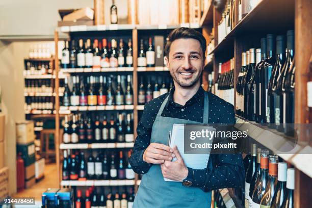 smiling wine cellar owner - bottle shop stock pictures, royalty-free photos & images