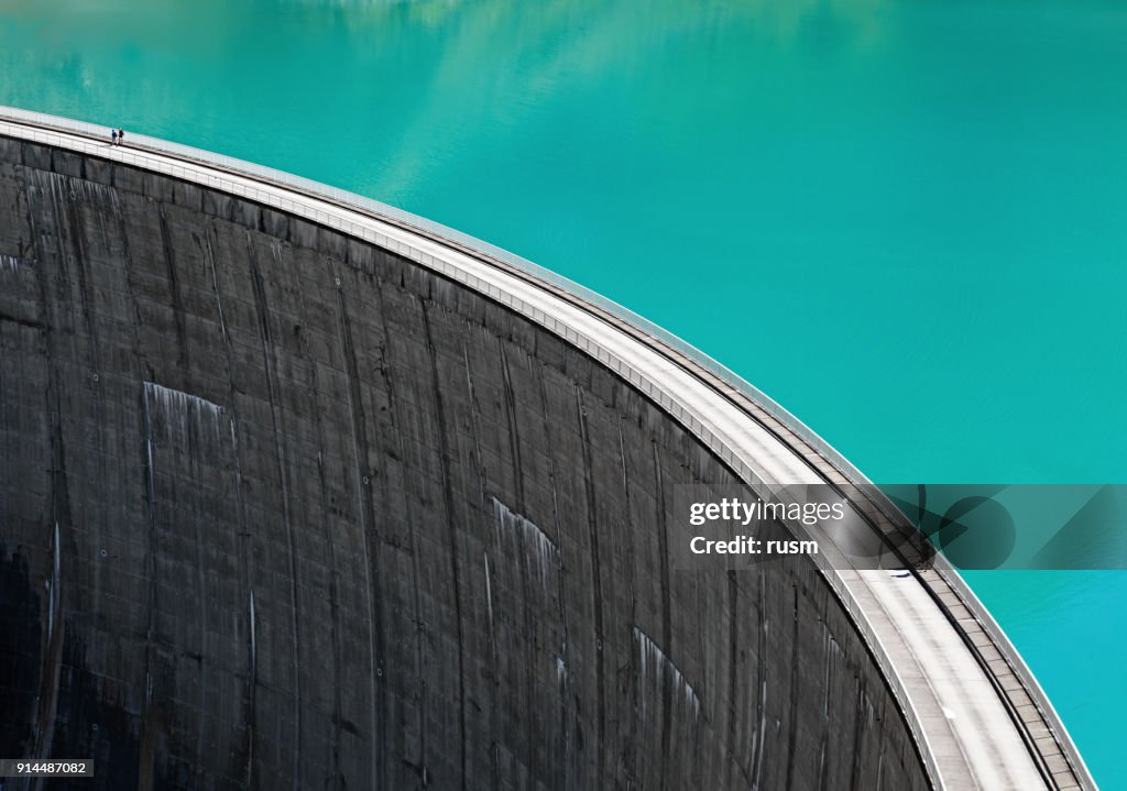 People walking on edge of Stausee Mooserboden Dam, Kaprun, Austria