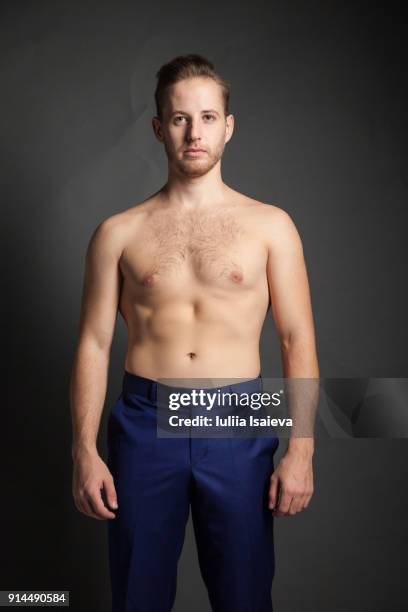 undressed man in blue pants - chest torso stock-fotos und bilder