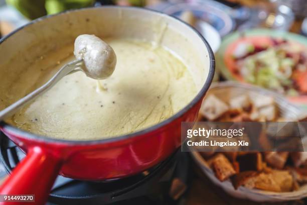 classic swiss cheese fondue with breads and potatoes, landmark of switzerland - hot pots stock-fotos und bilder