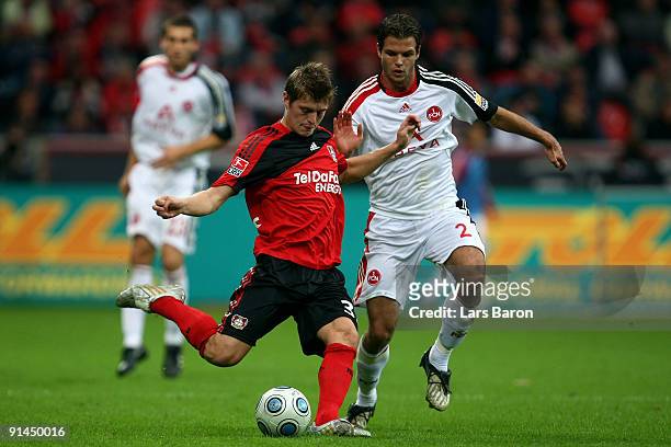 Toni Kroos of Leverkusen is challanged by Dennis Diekmeier of Nuernberg during the Bundesliga match between Bayer Leverkusen and 1. FC Nuernberg at...