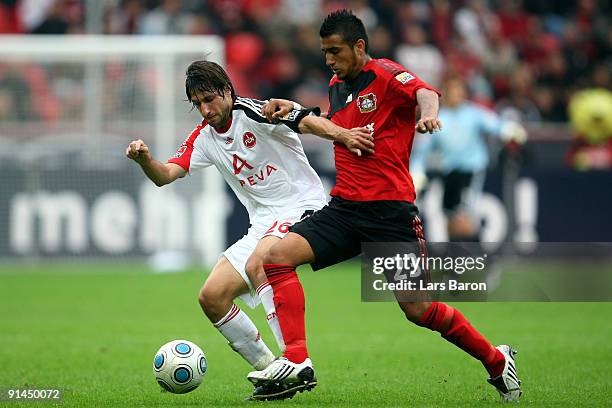 Thomas Broich of Nuernberg is challenged by Arturo Vidal of Leverkusen during the Bundesliga match between Bayer Leverkusen and 1. FC Nuernberg at...