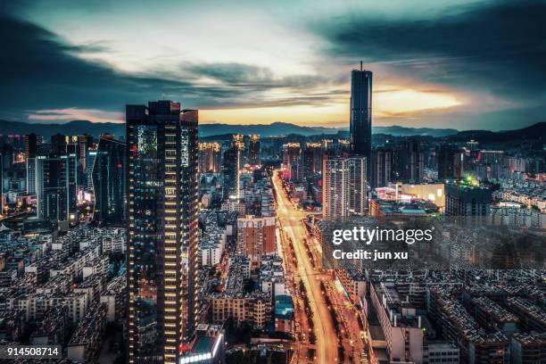 the modern city skyline - kunming stock-fotos und bilder
