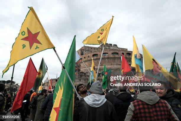 Members of Kurdish and Italian associations hold flags of Kurdistan Workers' Party , People's Protection Units , Kurdistan Communities Union and the...