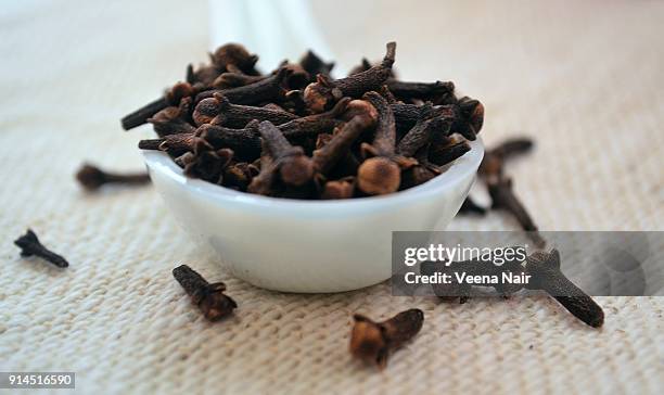 close-up of clove/spice in a ceramic spoon - clove stock pictures, royalty-free photos & images