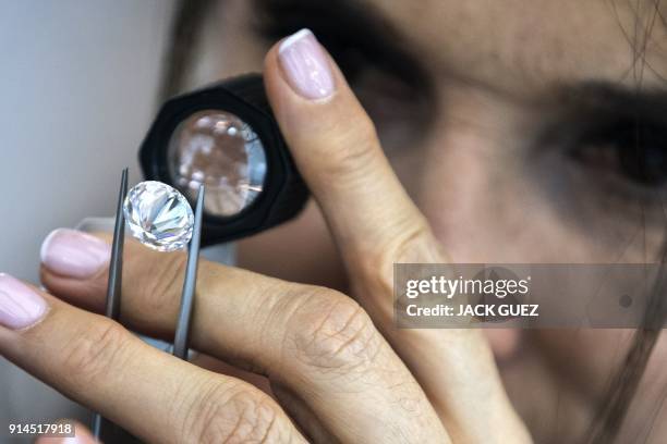 Foreign buyer checks the quality of a diamond during the International Diamond Week in the Israeli town of Ramat Gan, east of Tel Aviv, on February...