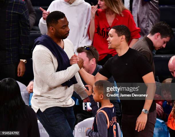 Justin Tuck and Trevor Noah attend the New York Knicks vs Atlanta Hawks game at Madison Square Garden on February 4, 2018 in New York City.