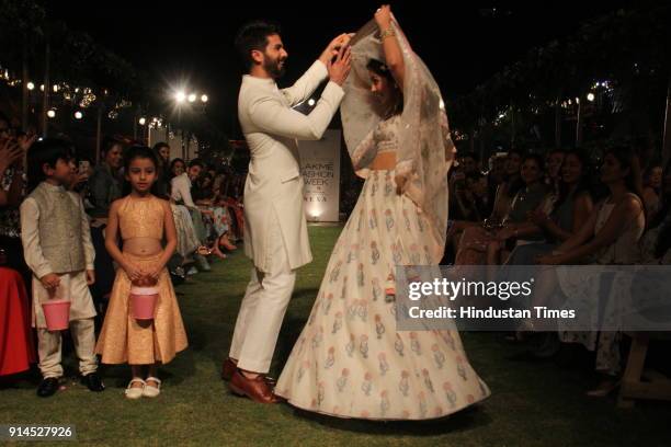 Indian Bollywood actor Shahid Kapoor with his wife Mira Rajput showcase a creation by designer Anita Dongre at the Lakmé Fashion Week Summer Resort...