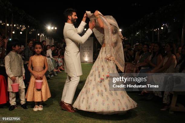 Indian Bollywood actor Shahid Kapoor with his wife Mira Rajput showcase a creation by designer Anita Dongre at the Lakmé Fashion Week Summer Resort...