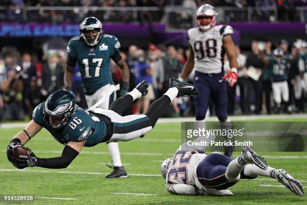 Zach Ertz of the Philadelphia Eagles scores an 11-yard fourth quarter touchdown past Devin McCourty of the New England Patriots in Super Bowl LII at...