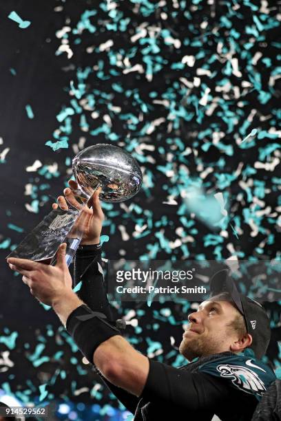 Quarterback Nick Foles of the Philadelphia Eagles raises the Vince Lombardi Trophy after defeating the New England Patriots, 41-33, in Super Bowl LII...