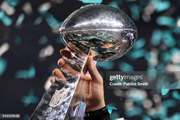 Quarterback Nick Foles of the Philadelphia Eagles raises the Vince Lombardi Trophy after defeating the New England Patriots, 41-33, in Super Bowl LII...