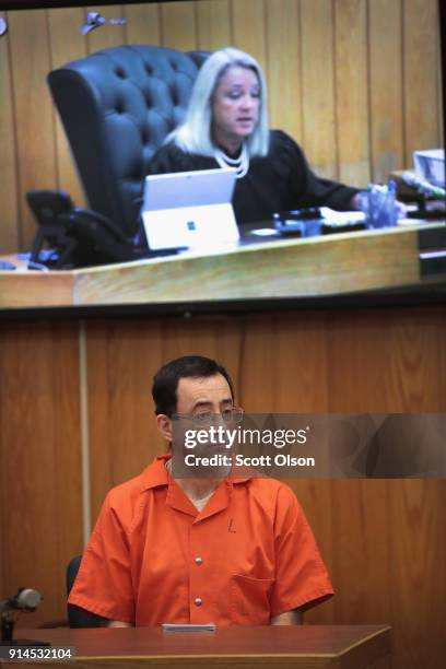 Larry Nassar listens as he is sentenced by Judge Janice Cunningham for three counts of criminal sexual assault in Eaton County Circuit Court on...