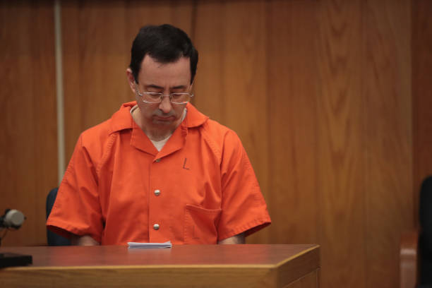 Larry Nassar sits in court listening to statements before being sentenced by Judge Janice Cunningham for three counts of criminal sexual assault in...