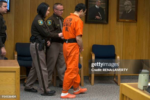 Former Michigan State University and USA Gymnastics doctor Larry Nassar gets escorted out of court on the final day of sentencing in Eaton County...