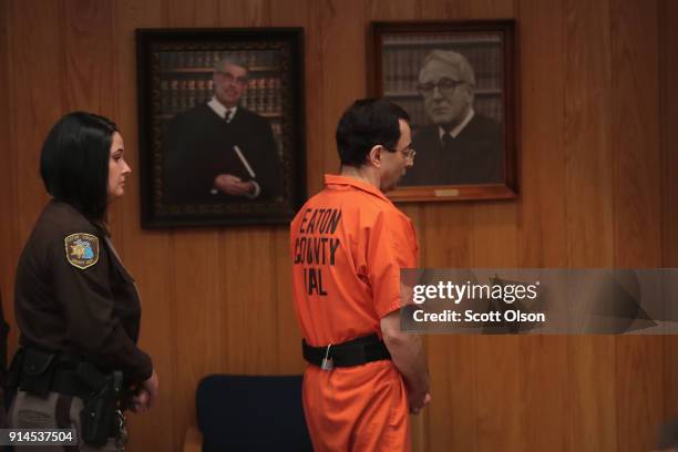 Larry Nassar is led from the courtroom after being sentenced by Judge Janice Cunningham to 40 to 125 years in prison for three counts of criminal...