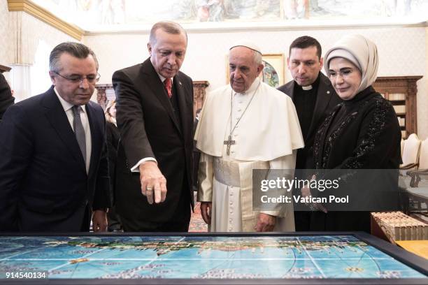 Pope Francis exchanges gifts with President of Turkey Recep Tayyip Erdogan and his wife Emine Erdogan during an audience at the Apostolic Palace on...