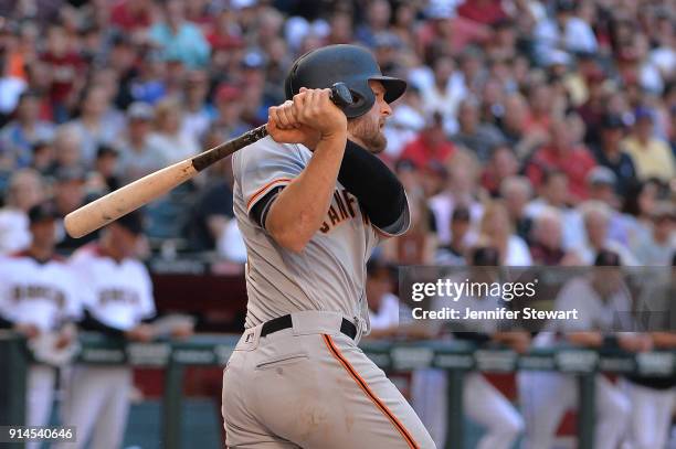 Conor Gillaspie of the San Francisco Giants hits a sacrifice fly to center in the ninth inning against the Arizona Diamondbacks at Chase Field on...