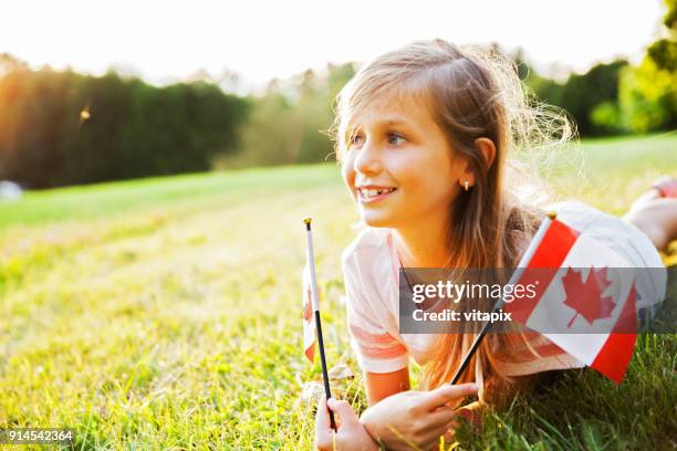 canada day - patriotic little girl with the canadian flag - canada day celebration stock pictures, royalty-free photos & images