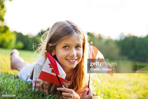 canada day - patriotic little girl with the canadian flag - canada day people stock pictures, royalty-free photos & images