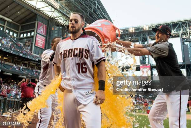 Yasmany Tomas and Nick Ahmed of the Arizona Diamondbacks dump Chris Owings with sports drink after hitting the game winning RBI single against the...