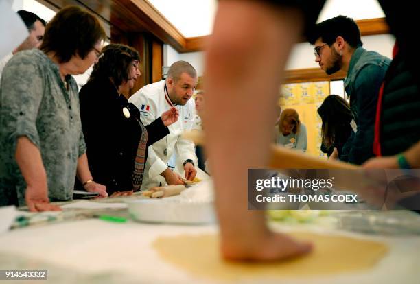 French chef Guillaume Gomez, head chef at France's Elysee palace, answers journalists question during a cooking class for teenage members of an...