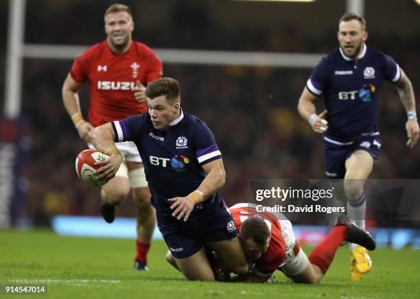 Huw Jones of Scotland breaks with the ball as Hadleigh Parkes tackles during the NatWest Six Nations match between Wales and Scotland at the...