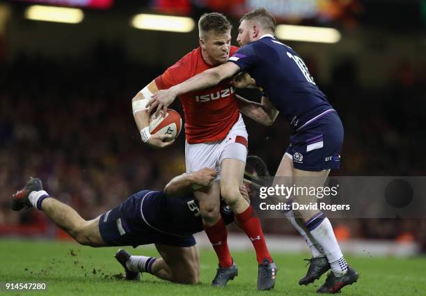 Gareth Anscombe of Wales holds off Finn Russell during the NatWest Six Nations match between Wales and Scotland at the Principality Stadium on...