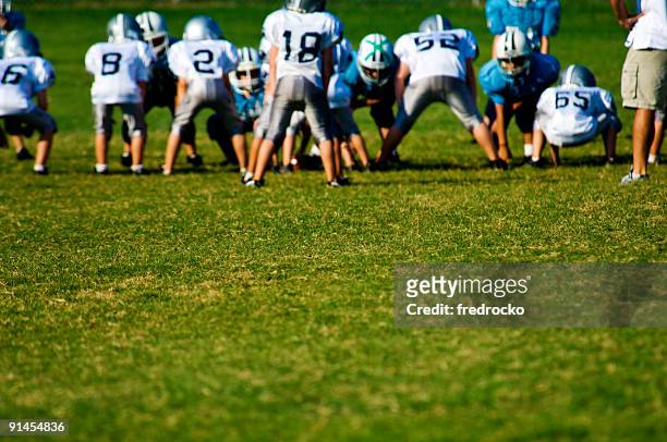 american football players on football field at football game - quarterback teenager stock pictures, royalty-free photos & images