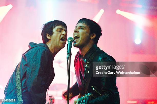 Johnny Marr and Ryan Jarman of The Cribs performs on stage at Manchester Apollo on October 2, 2009 in Manchester, England.
