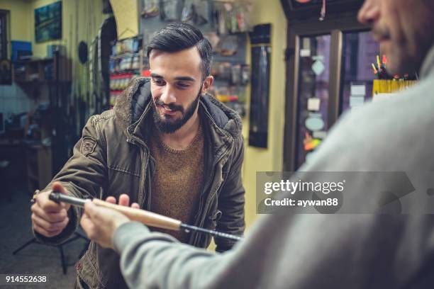 fisherman buying fishing equipment - barbed hook stock pictures, royalty-free photos & images