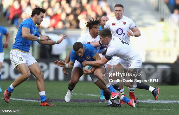 Matteo Minozzi of Italy is tackled by Owen Farrell and Anthony Watson during the NatWest Six Nations match between Italy and England at Stadio...