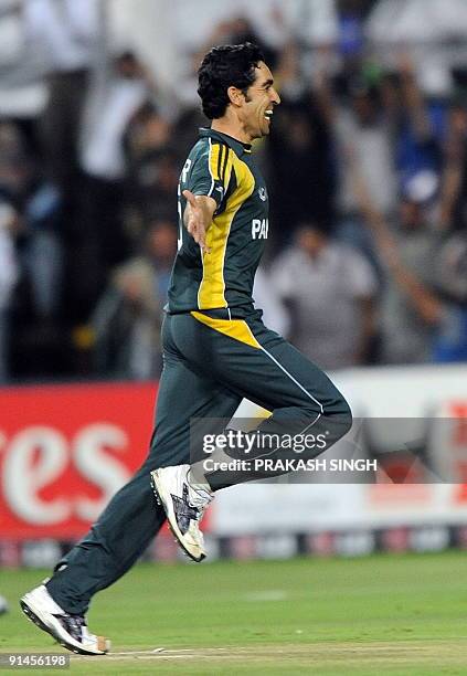 Pakistan's Umar Gul celebrates the wicket of New Zealand's Martin Guptill during the ICC Champions Trophy's second semi final match between Pakistan...