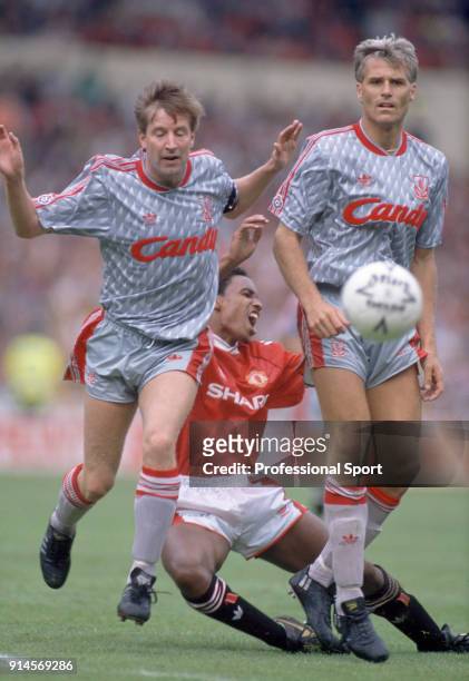 Paul Ince of Manchester United is blocked by Ronnie Whelan and Glenn Hysén of Liverpool during the FA Charity Shield at Wembley Stadium on August 18,...