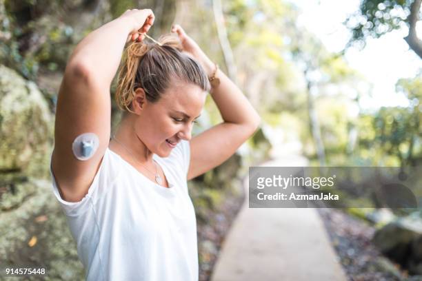 diabetic woman preparing for a run - chronic illness stock pictures, royalty-free photos & images
