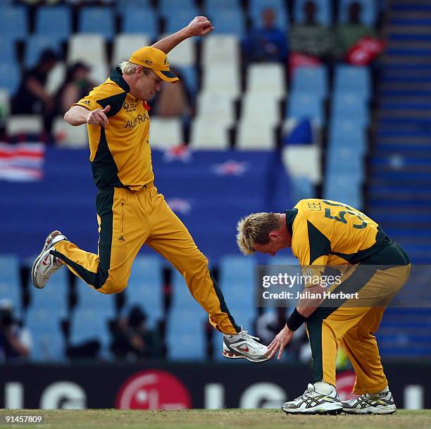 Cameron White leaps to join team mate Brett Lee in celebrating the wicket of New Zealand's Grant Elliot during the ICC Champions Trophy Final between...