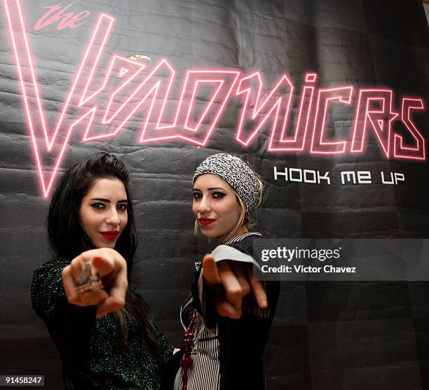 Lisa Origliasso and Jessica Origliasso of The Veronicas pose for photographs during their showcase and autograph signing at MixUp Plaza Loreto on...