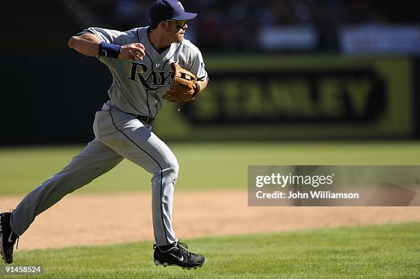 Third baseman Evan Longoria#3 of the Tampa Bay Rays fields his position as he throws to first base after fielding a slowly hit ground ball during the...